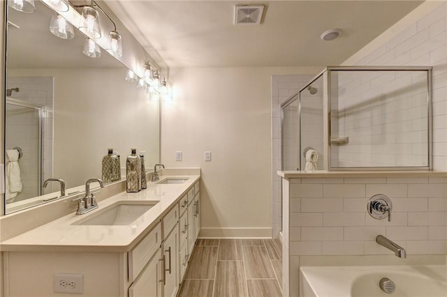 bathroom featuring visible vents, a sink, baseboards, and tiled shower