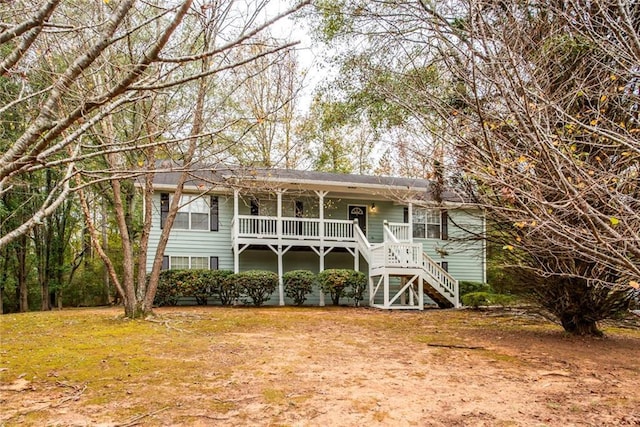 view of front of home featuring stairs and a front lawn