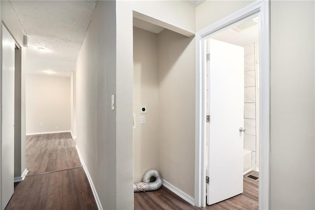 hall with a textured ceiling and hardwood / wood-style flooring