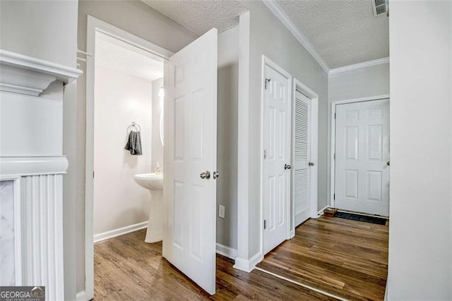 5 Corbel Way, Newnan, GA 30265 - hall featuring a textured ceiling, wood finished floors, crown molding, and baseboards