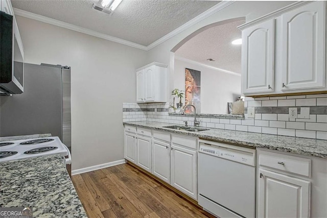 5 Corbel Way, Newnan, GA 30265 - kitchen featuring white dishwasher, a sink, stainless steel microwave, arched walkways, and a textured ceiling