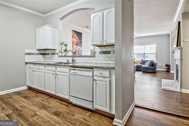 5 Corbel Way, Newnan, GA 30265 - kitchen featuring white dishwasher, a sink, a textured ceiling, white cabinets, and decorative backsplash