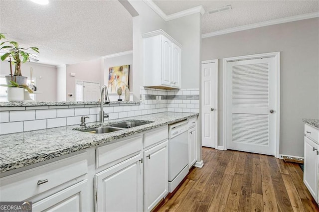 5 Corbel Way, Newnan, GA 30265 - kitchen featuring a sink, dishwasher, a textured ceiling, backsplash, and white cabinetry