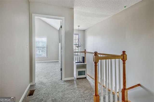 5 Corbel Way, Newnan, GA 30265 - hall featuring an upstairs landing, carpet flooring, baseboards, and a textured ceiling