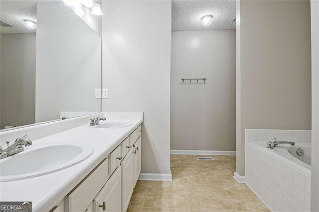 5 Corbel Way, Newnan, GA 30265 - bathroom with a textured ceiling, baseboards, tile patterned flooring, tiled bath, and double vanity