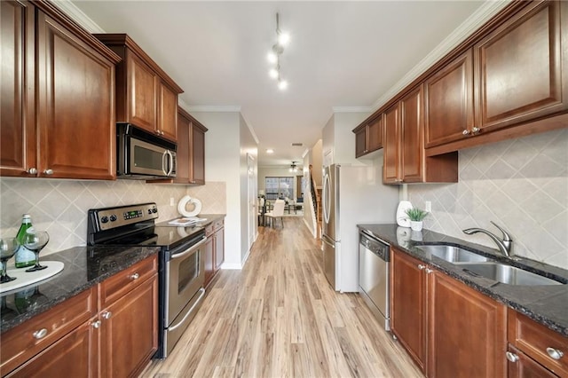 kitchen featuring crown molding, light wood-style flooring, appliances with stainless steel finishes, a ceiling fan, and a sink