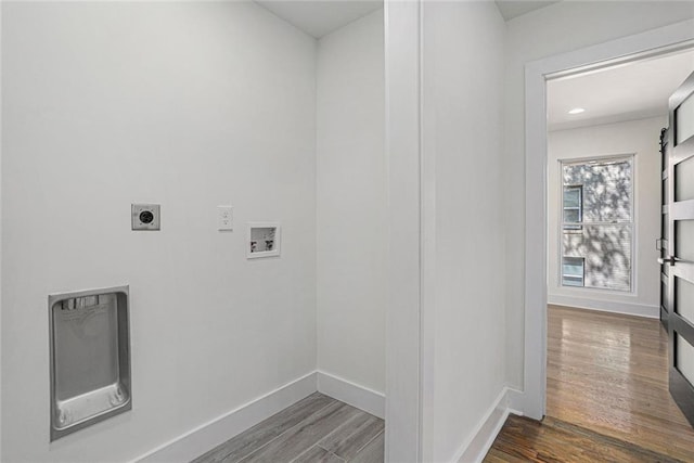 washroom with electric dryer hookup, washer hookup, wood finished floors, and laundry area