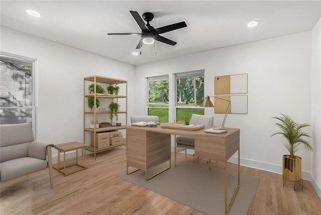 office space featuring recessed lighting, baseboards, light wood-type flooring, and a ceiling fan