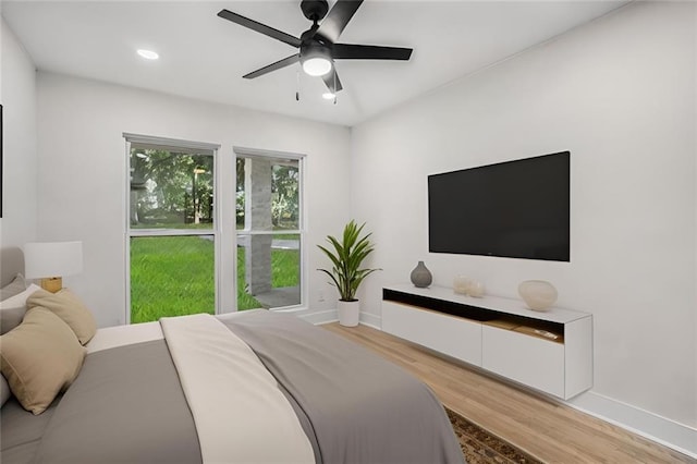 bedroom featuring a ceiling fan, recessed lighting, light wood-style floors, and baseboards