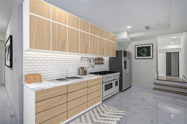 kitchen with marble finish floor, light brown cabinetry, backsplash, stainless steel fridge with ice dispenser, and range with two ovens