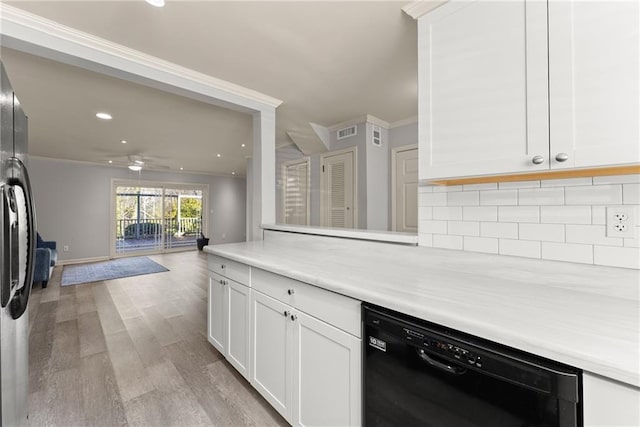 kitchen with white cabinets, ornamental molding, black dishwasher, and light wood-type flooring