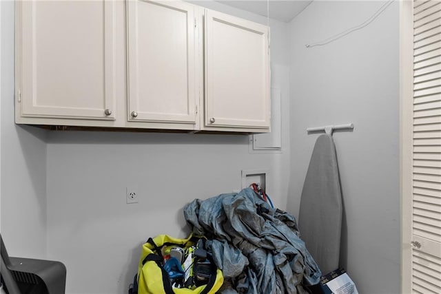 clothes washing area featuring washer hookup and cabinets