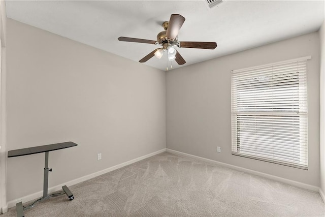 carpeted spare room with ceiling fan