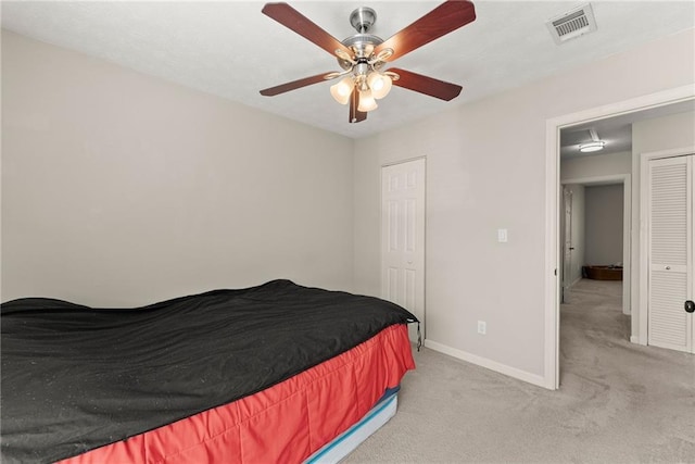 bedroom with light carpet and ceiling fan