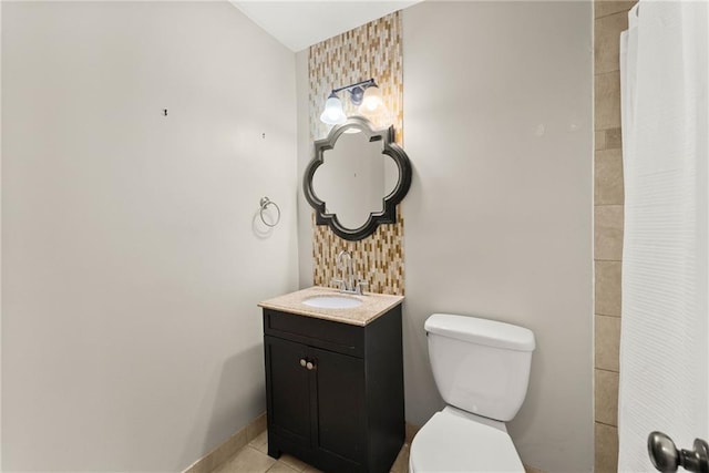 bathroom with vanity, tile patterned floors, and toilet