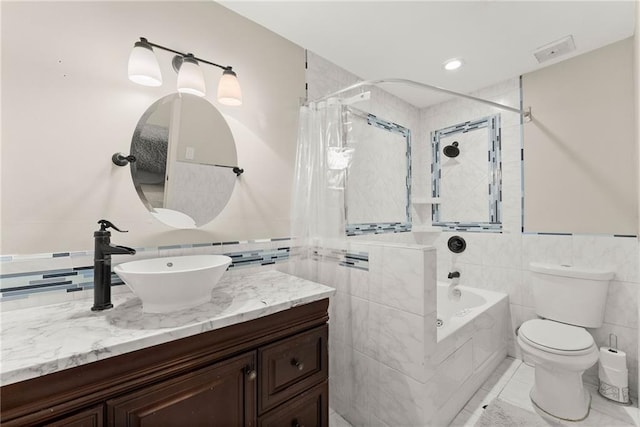 full bathroom featuring vanity, toilet, shower / tub combo, and tile walls