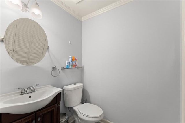 bathroom featuring crown molding, vanity, and toilet