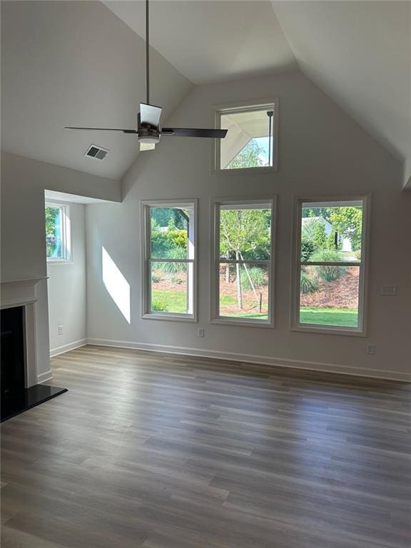 208 Saratoga Dr, Acworth, GA 30102 - unfurnished living room with ceiling fan, lofted ceiling, wood finished floors, a fireplace with raised hearth, and baseboards