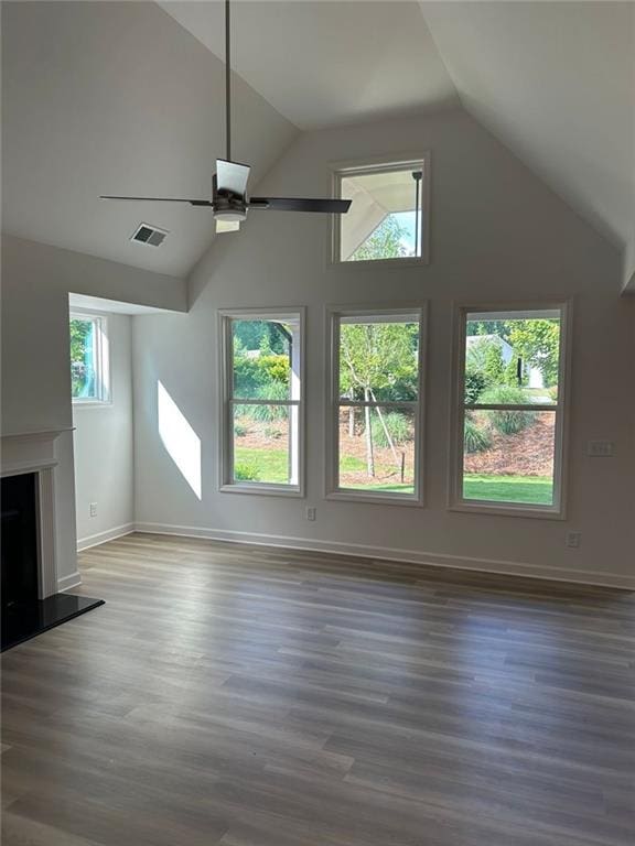 208 Saratoga Dr, Acworth, GA 30102 - unfurnished living room featuring a ceiling fan, vaulted ceiling, wood finished floors, and a fireplace with raised hearth