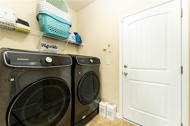 laundry area featuring independent washer and dryer and light tile patterned flooring