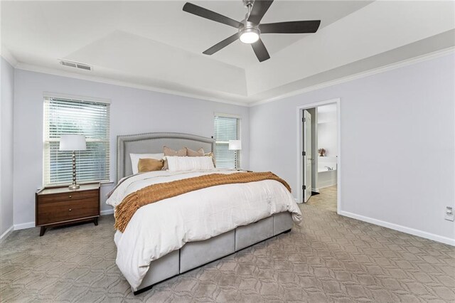 carpeted bedroom featuring ornamental molding, a raised ceiling, and ceiling fan