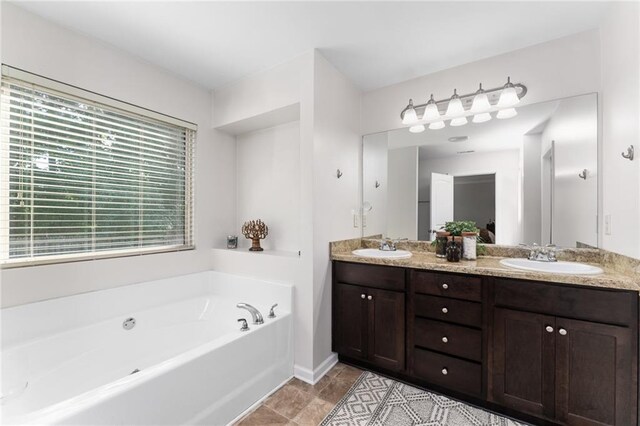 bathroom featuring vanity and a tub to relax in