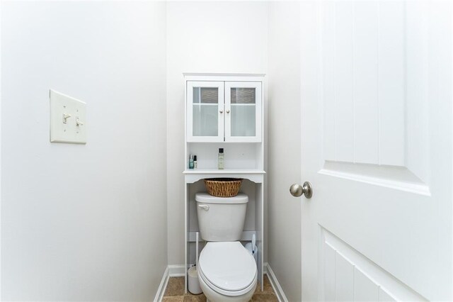 bathroom with toilet and tile patterned flooring