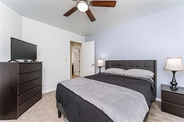 bedroom with light carpet and ceiling fan