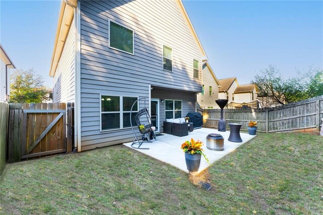 rear view of property featuring a patio area and a lawn