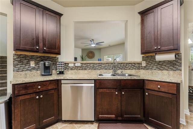 kitchen featuring sink, dishwasher, light stone countertops, and backsplash