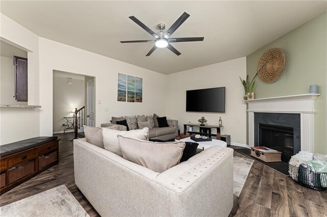 living room with dark hardwood / wood-style floors and ceiling fan