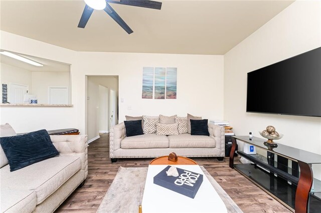 living room featuring hardwood / wood-style flooring and ceiling fan