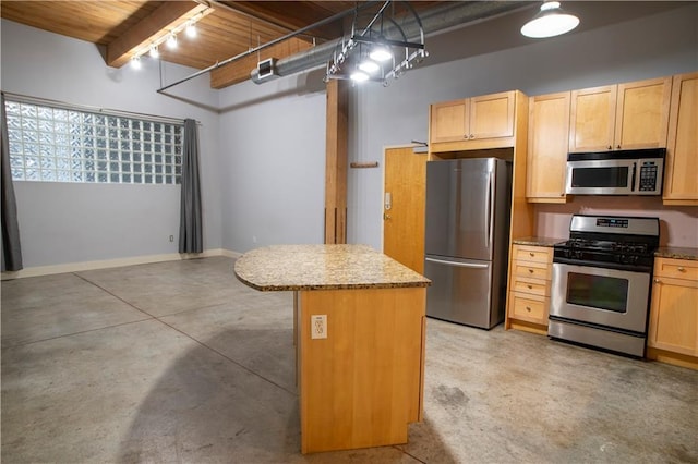 kitchen with concrete floors, a kitchen island, light brown cabinetry, track lighting, and appliances with stainless steel finishes