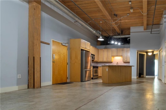 kitchen featuring a kitchen island, concrete floors, baseboards, a high ceiling, and stainless steel appliances