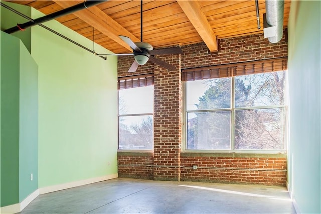 interior space with beam ceiling, brick wall, wooden ceiling, baseboards, and concrete flooring