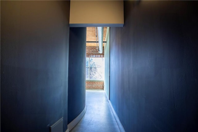 hallway featuring concrete flooring