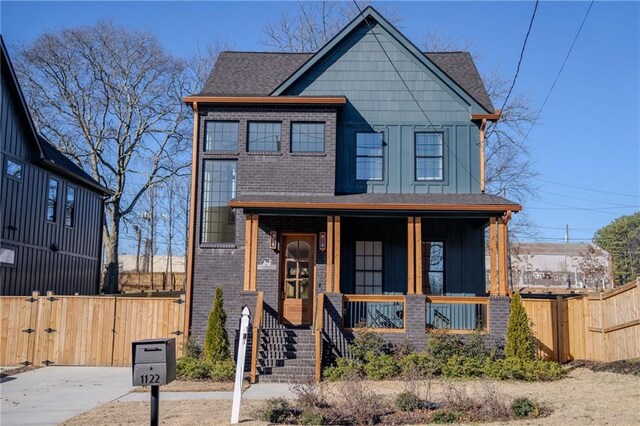 1122 Rice St NW, Atlanta, GA 30318 - view of front facade with a porch, board and batten siding, brick siding, a gate, and a shingled roof