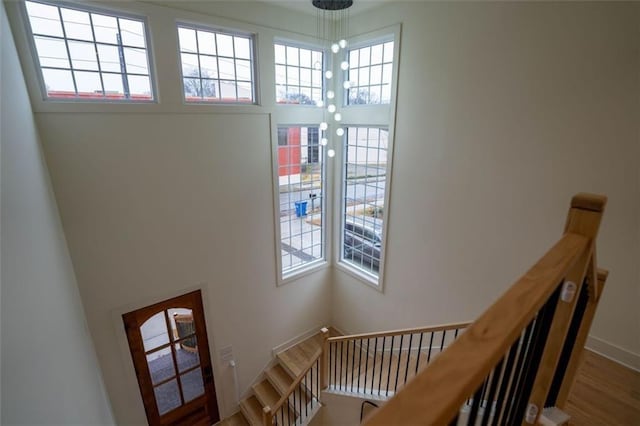 1122 Rice St NW, Atlanta, GA 30318 - stairway featuring a high ceiling, wood finished floors, and baseboards
