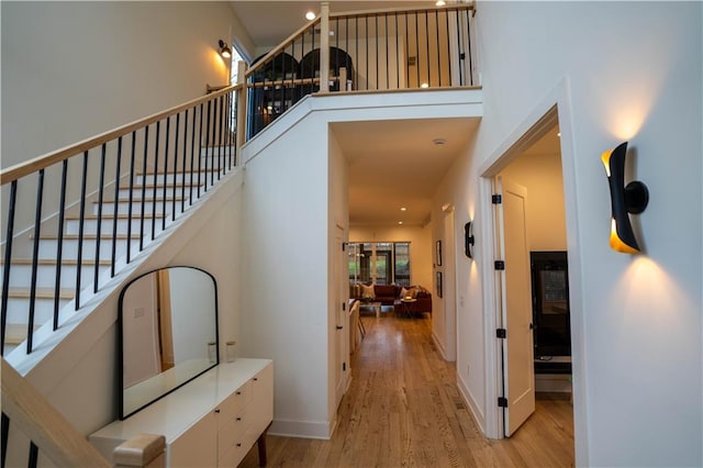 1122 Rice St NW, Atlanta, GA 30318 - staircase with wood finished floors, a towering ceiling, recessed lighting, and baseboards