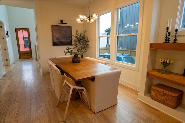 1122 Rice St NW, Atlanta, GA 30318 - dining room featuring light wood-type flooring, a chandelier, plenty of natural light, and baseboards