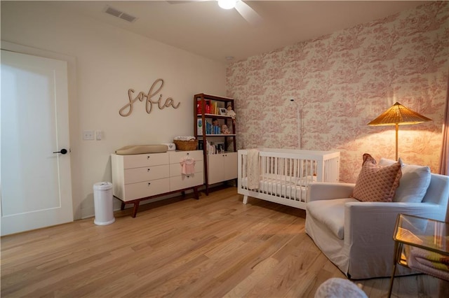 1122 Rice St NW, Atlanta, GA 30318 - bedroom featuring wallpapered walls, wood finished floors, and ceiling fan