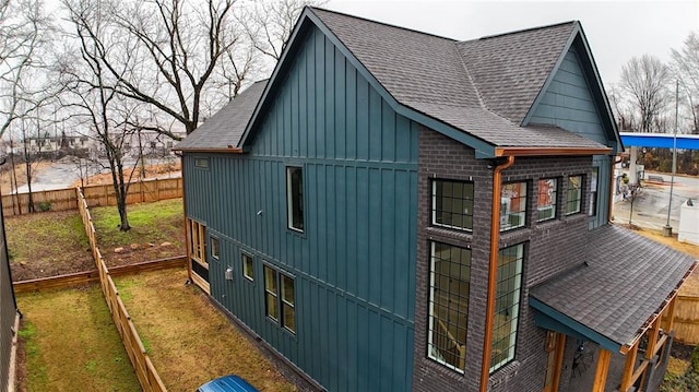 1122 Rice St NW, Atlanta, GA 30318 - view of property exterior featuring roof with shingles, board and batten siding, and brick siding