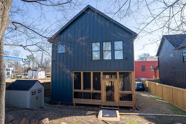 1122 Rice St NW, Atlanta, GA 30318 - back of house with board and batten siding, a sunroom, and a fenced backyard