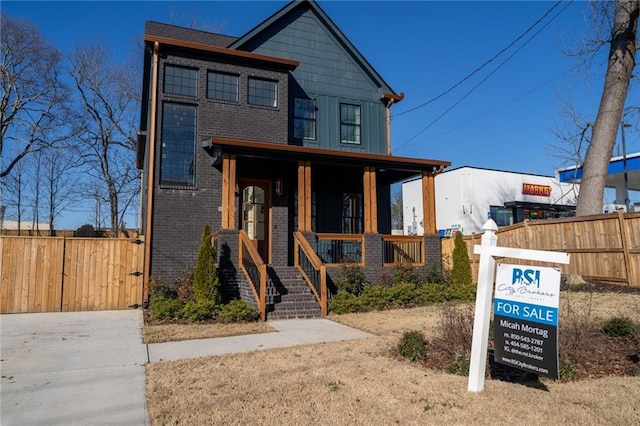 1122 Rice St NW, Atlanta, GA 30318 - view of front facade with a porch, brick siding, and board and batten siding
