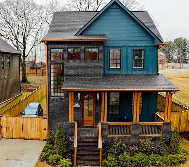 1122 Rice St NW, Atlanta, GA 30318 - view of front of home with board and batten siding, a porch, and roof with shingles