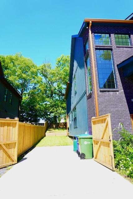 1122 Rice St NW, Atlanta, GA 30318 - view of side of property featuring brick siding and board and batten siding