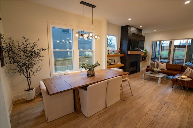 1122 Rice St NW, Atlanta, GA 30318 - dining space featuring healthy amount of natural light, light wood-style floors, a large fireplace, recessed lighting, and baseboards