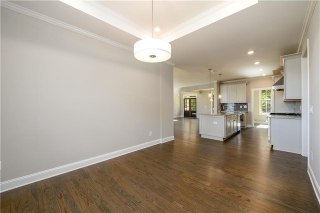 unfurnished living room featuring ornamental molding and dark hardwood / wood-style flooring