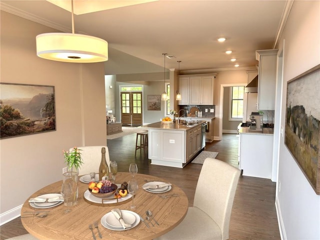 dining space featuring ornamental molding, french doors, and dark hardwood / wood-style flooring