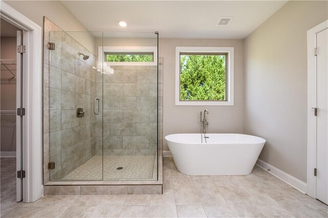 bathroom featuring separate shower and tub